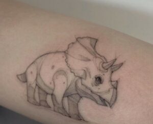 cartoon dinosaur tattoo